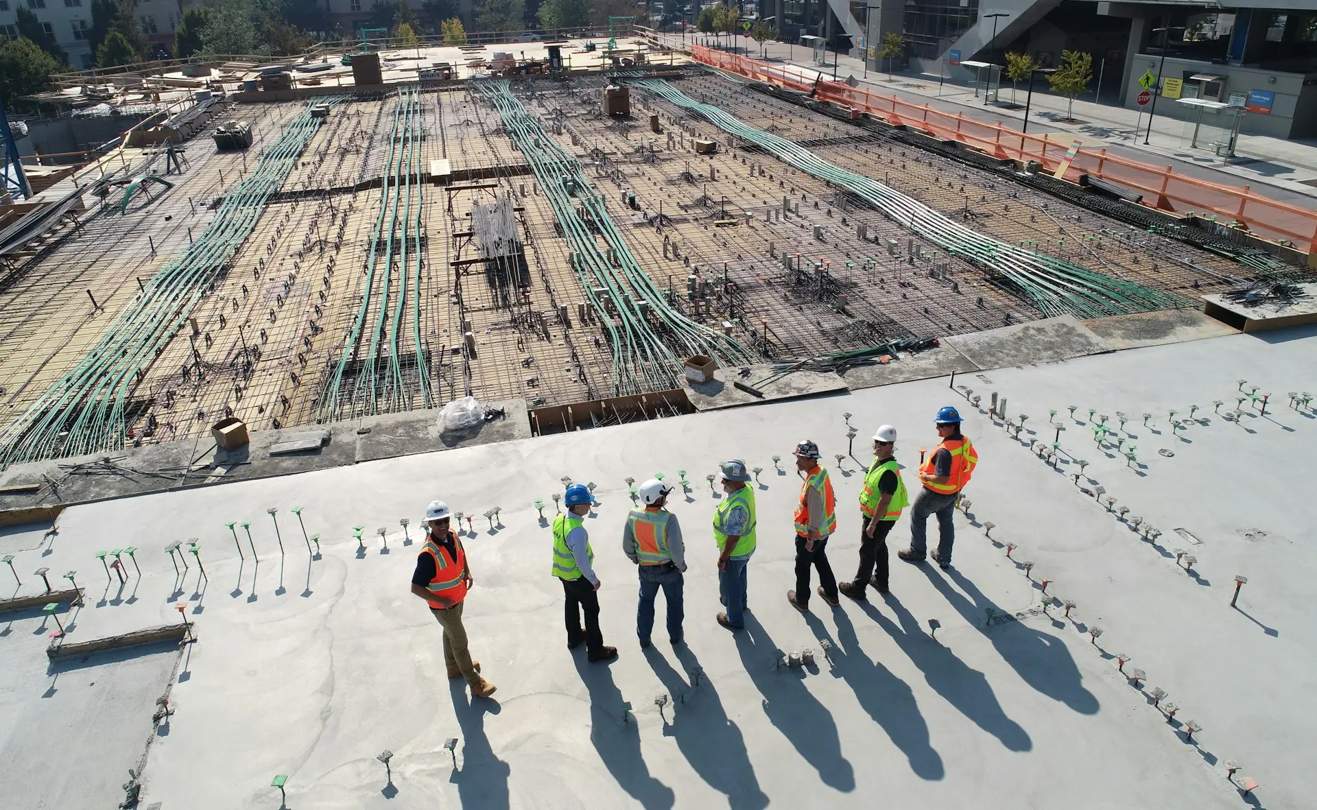 seven construction workers standing on white field